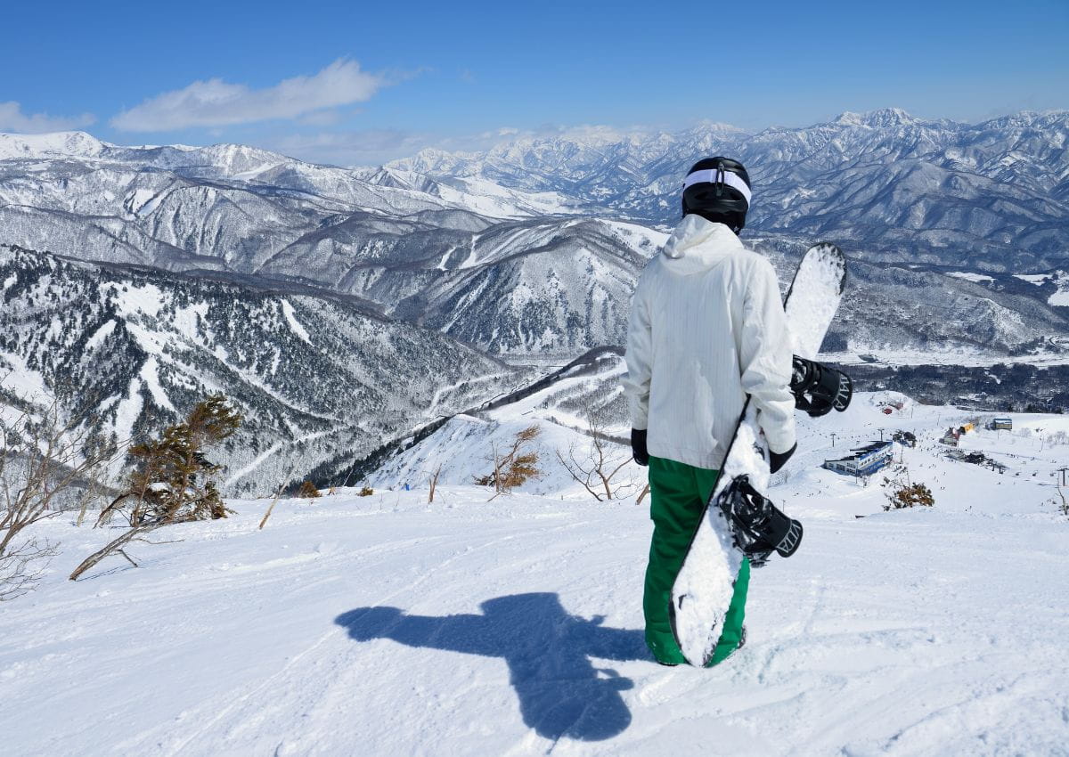 Snowboarder im Skigebiet Hakuba Goryu, Japan