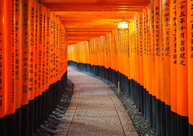 Weg durch orangefarbene Torii-Tore an einem japanischen Schrein