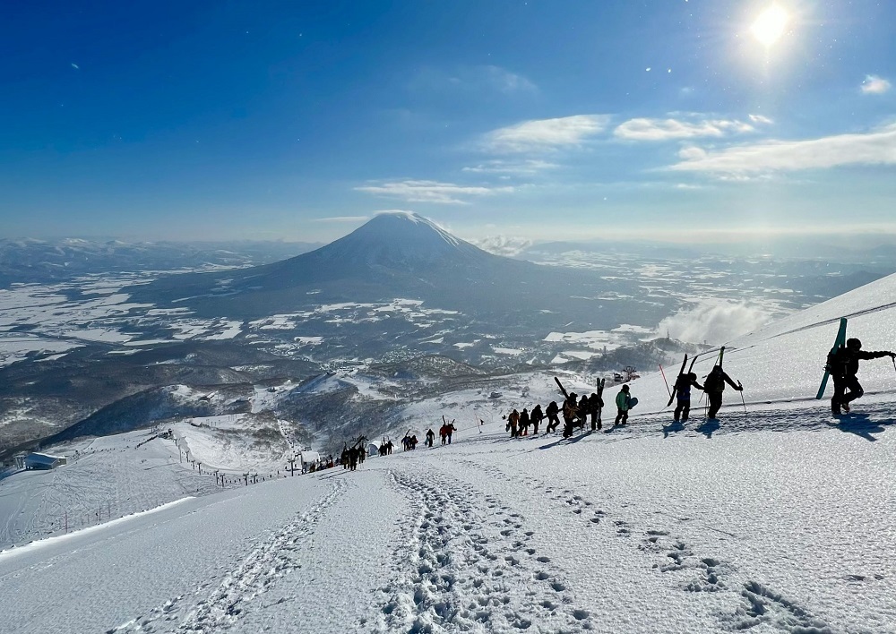 Skifahrer und Snowboarder im verschneiten Niseko auf Hokkaidō, Japan